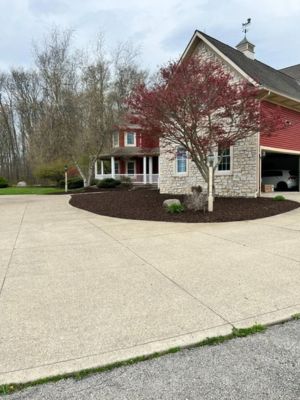 Mulched driveway curve at a red barn home